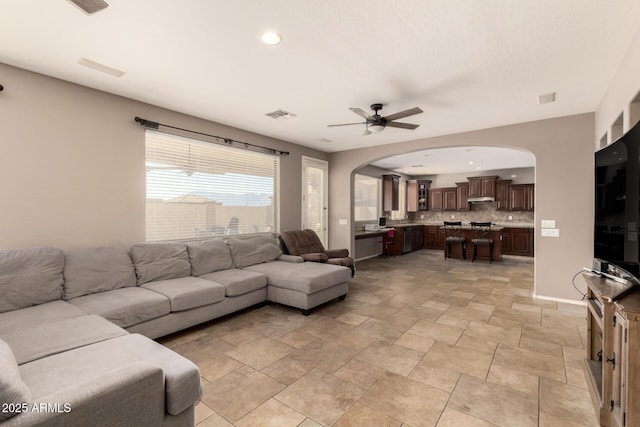 living room featuring recessed lighting, visible vents, arched walkways, and ceiling fan