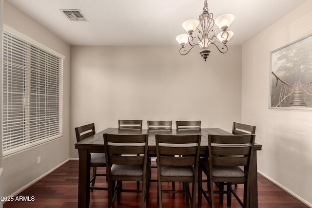 dining space with a notable chandelier, visible vents, baseboards, and dark wood-style flooring