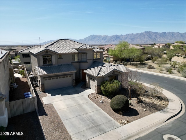 view of front of house featuring a tiled roof, stucco siding, a garage, stone siding, and driveway