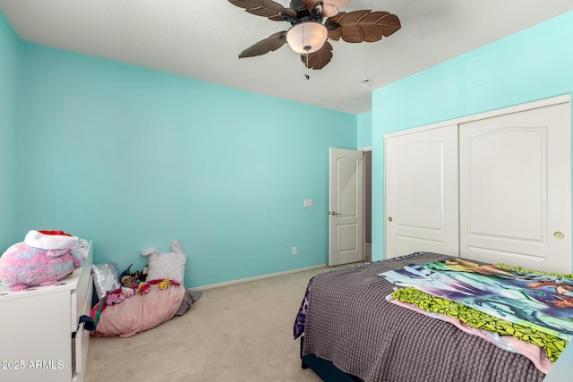 carpeted bedroom with a closet, a ceiling fan, and baseboards