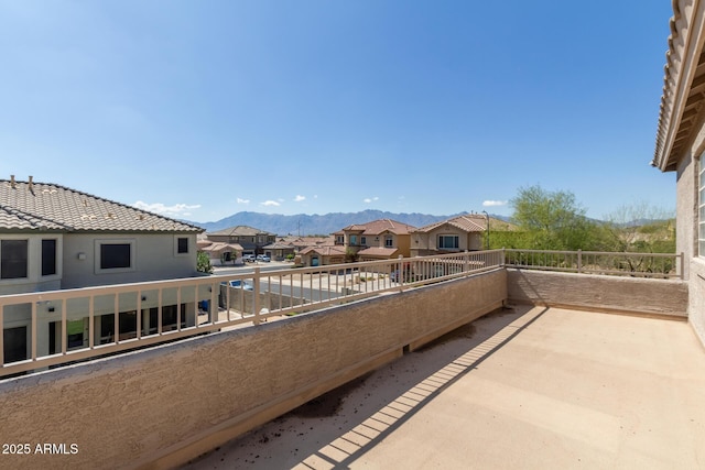 balcony with a residential view and a mountain view