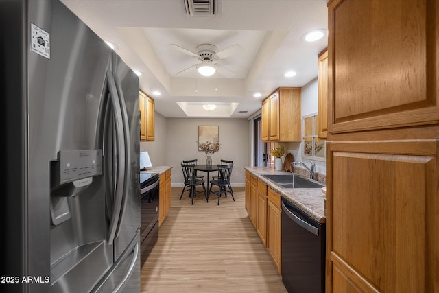 kitchen with stainless steel refrigerator with ice dispenser, a raised ceiling, visible vents, a sink, and dishwasher