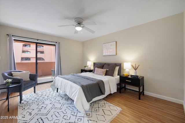 bedroom with baseboards, light wood-type flooring, a ceiling fan, and access to exterior