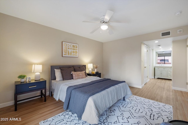 bedroom with baseboards, ceiling fan, visible vents, and light wood-style floors