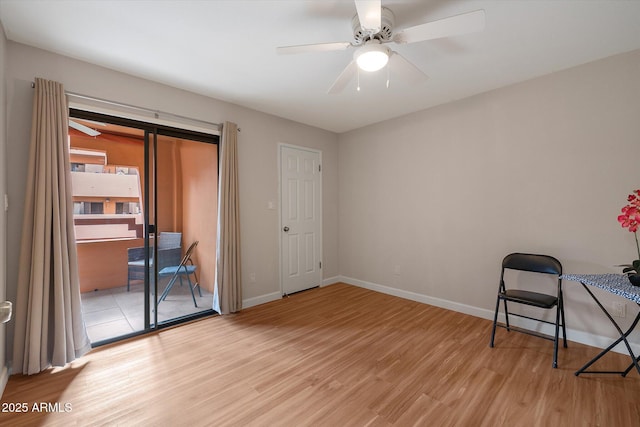 interior space with light wood-type flooring, ceiling fan, and baseboards