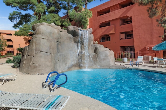 community pool featuring a patio area and fence