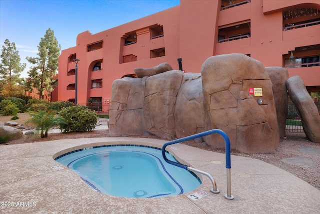 view of swimming pool featuring a community hot tub