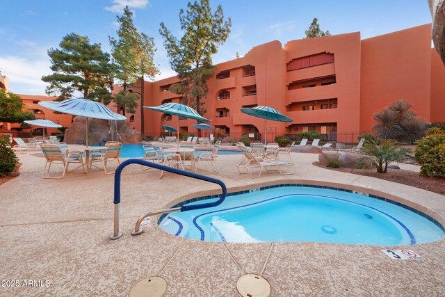 view of pool featuring a patio area and a community hot tub