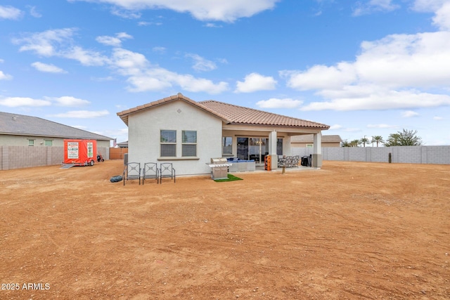 back of property with a patio