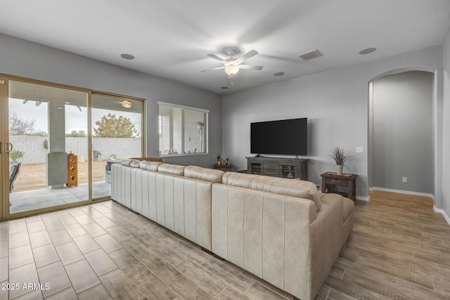 living room featuring ceiling fan and light hardwood / wood-style floors