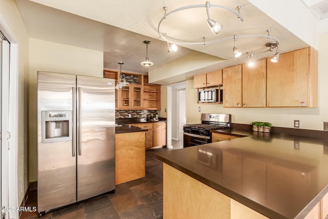 kitchen featuring rail lighting, stainless steel appliances, decorative backsplash, decorative light fixtures, and kitchen peninsula