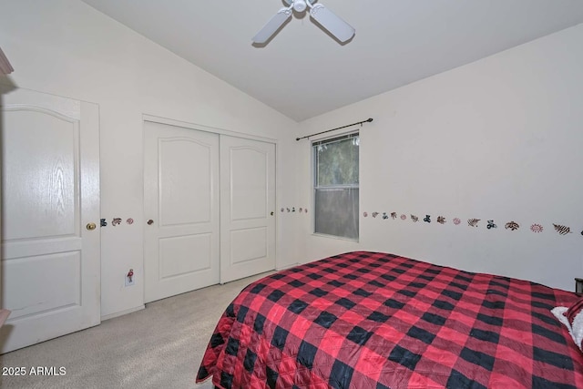 bedroom featuring ceiling fan, lofted ceiling, light carpet, and a closet