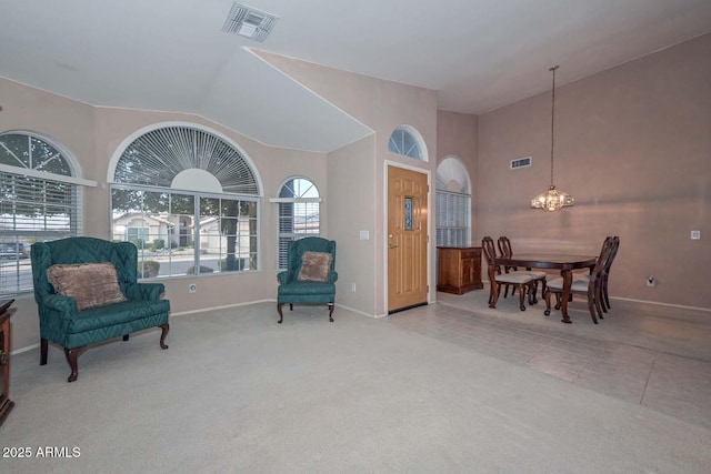 living area with light tile patterned floors, vaulted ceiling, and a notable chandelier