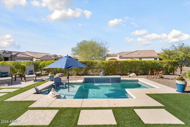 view of swimming pool with pool water feature and a patio