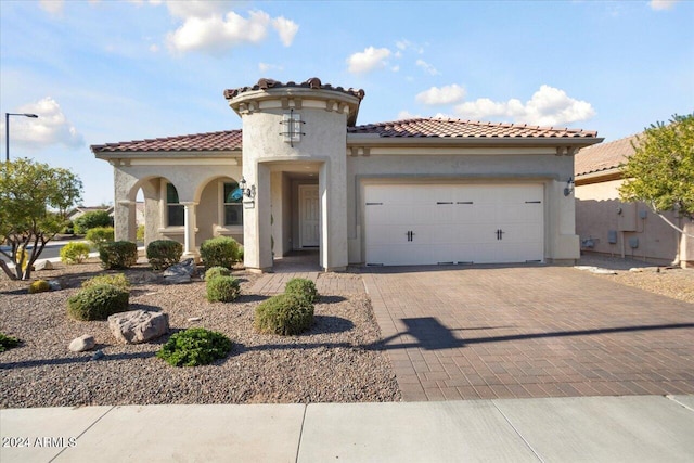 mediterranean / spanish home featuring a garage