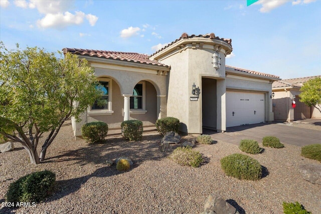 mediterranean / spanish home with a garage