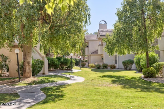 view of property's community with a lawn