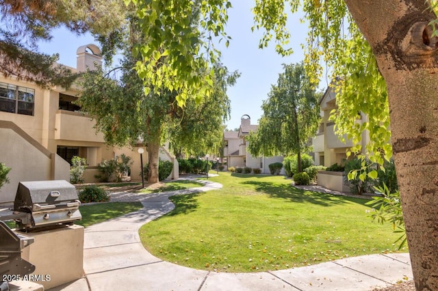 view of community featuring a lawn and a residential view
