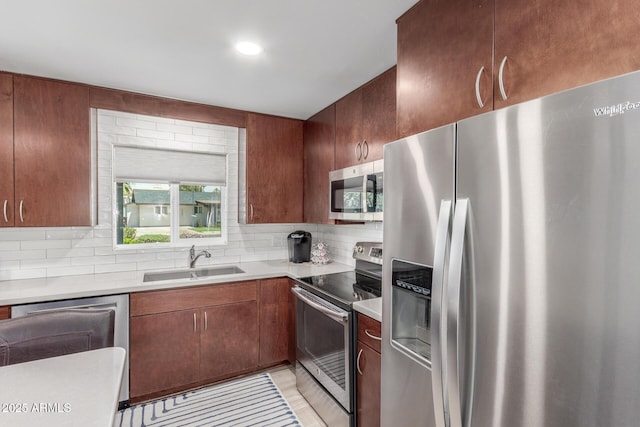 7727 E 4th St, Scottsdale, AZ 85251 - kitchen featuring light countertops, a sink, decorative backsplash, and stainless steel appliances