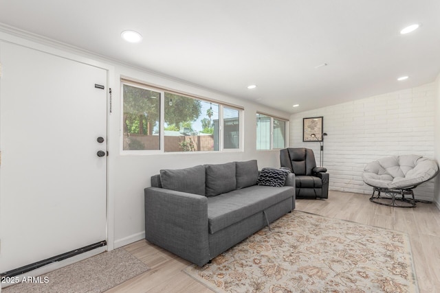 7727 E 4th St, Scottsdale, AZ 85251 - living area featuring brick wall, recessed lighting, wood finished floors, and lofted ceiling