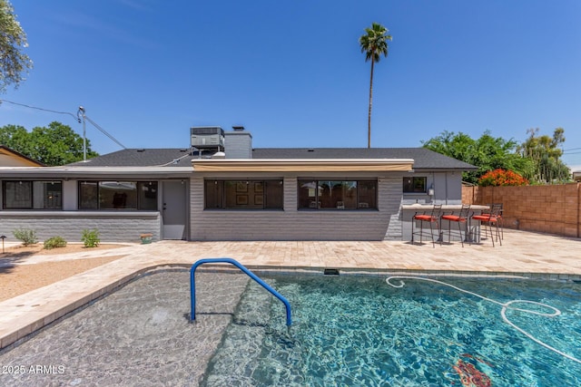7727 E 4th St, Scottsdale, AZ 85251 - rear view of property featuring fence, outdoor dry bar, an outdoor pool, a chimney, and a patio area