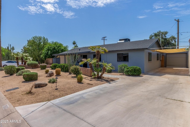 7727 E 4th St, Scottsdale, AZ 85251 - ranch-style home with concrete driveway, an attached garage, and roof with shingles