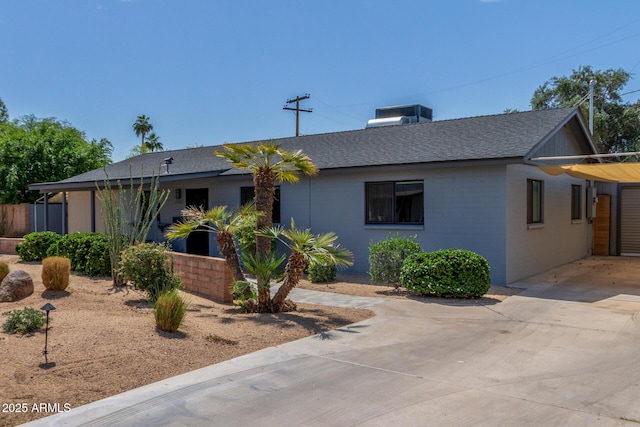 7727 E 4th St, Scottsdale, AZ 85251 - ranch-style house featuring a shingled roof and driveway