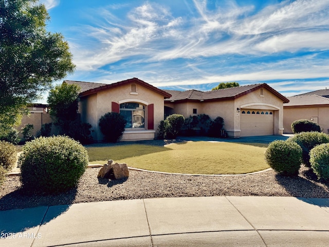 view of front of house featuring a garage and a front lawn