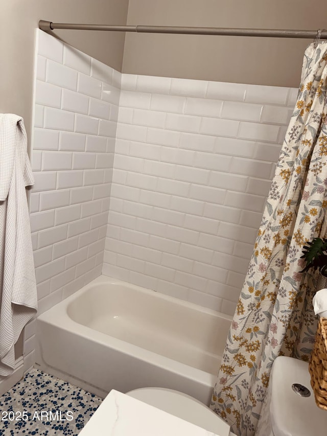 full bathroom featuring toilet, shower / tub combo with curtain, and tile patterned floors