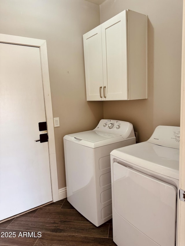 laundry room featuring dark wood-style flooring, cabinet space, independent washer and dryer, and baseboards