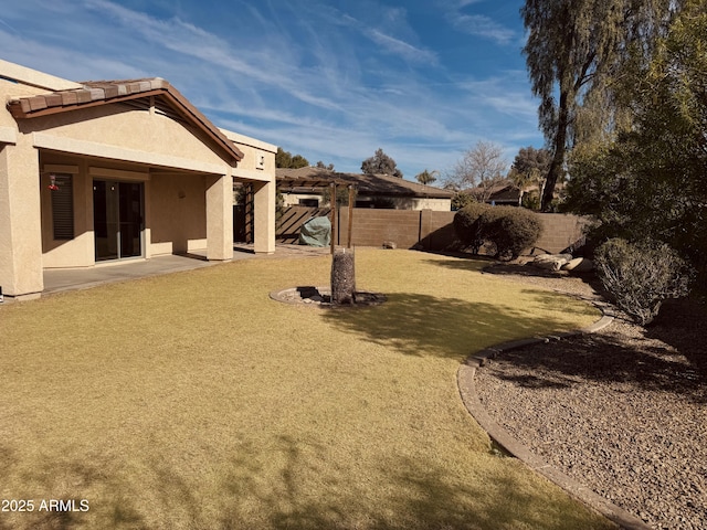 view of yard featuring a patio area and a fenced backyard