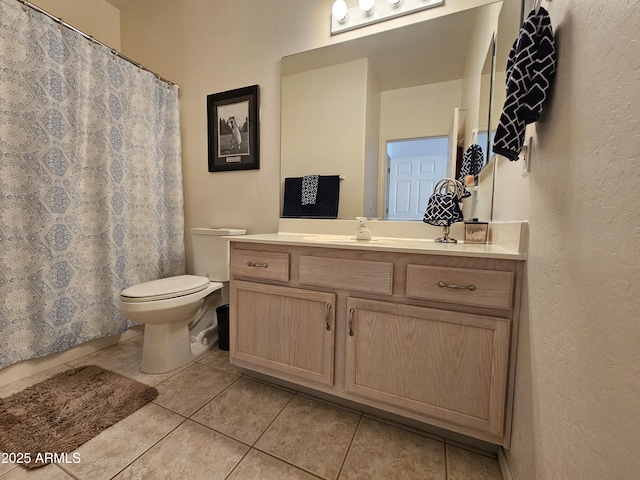 full bath with a textured wall, toilet, tile patterned floors, vanity, and a shower with curtain