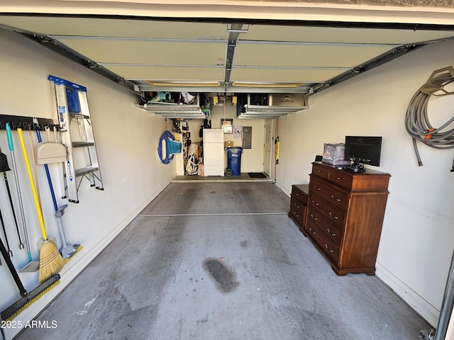 garage with electric panel and baseboards