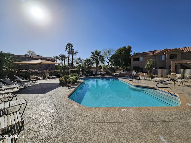 pool featuring a patio area and fence