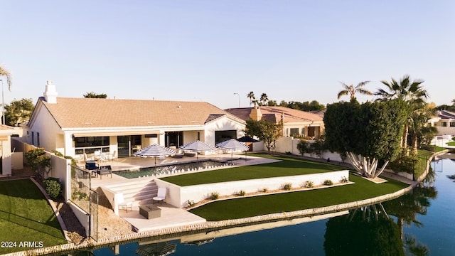 back of house featuring a patio and a water view