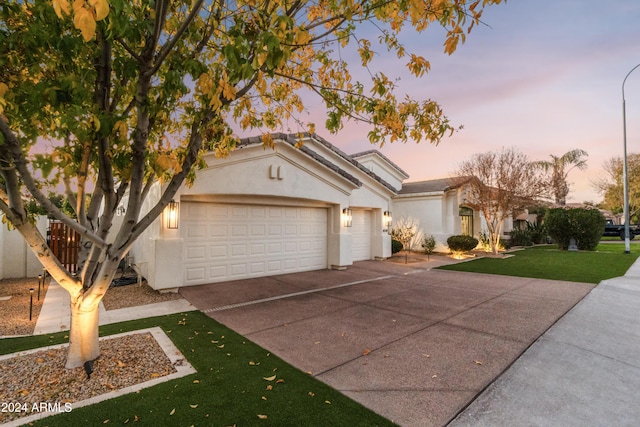 view of front facade featuring a yard and a garage