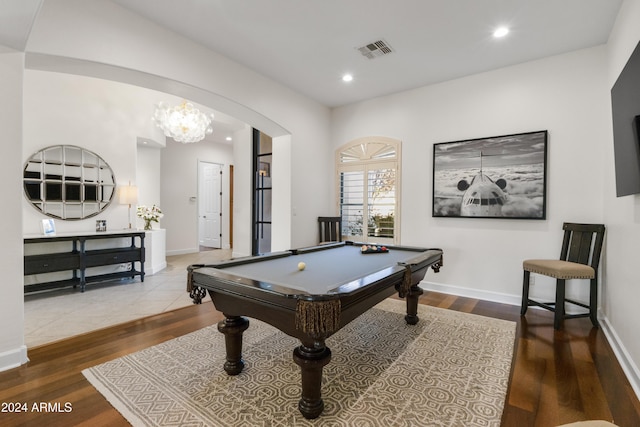 recreation room with wood-type flooring, pool table, and a notable chandelier