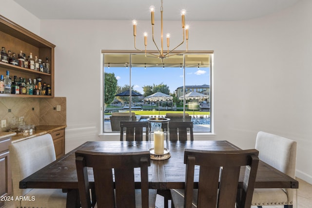 tiled dining area featuring a chandelier