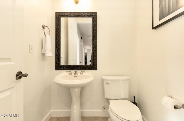 bathroom featuring tile patterned flooring and toilet