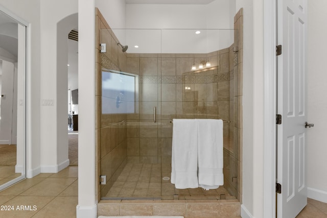 bathroom featuring tile patterned flooring and a shower with shower door