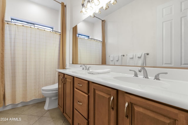 bathroom with toilet, tile patterned flooring, walk in shower, and vanity