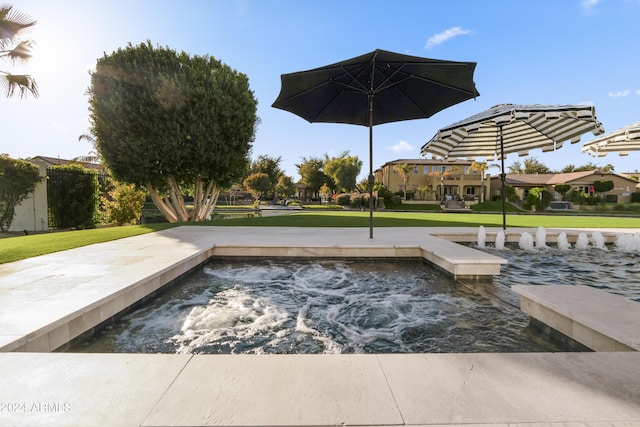 exterior space featuring a lawn and an in ground hot tub