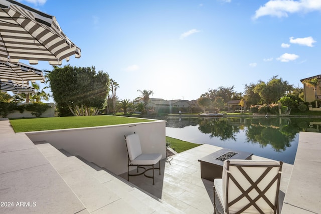 view of patio / terrace with a fire pit and a water view