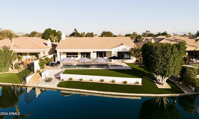 rear view of property featuring a water view and a patio