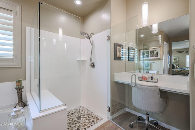 bathroom with an enclosed shower and hardwood / wood-style flooring