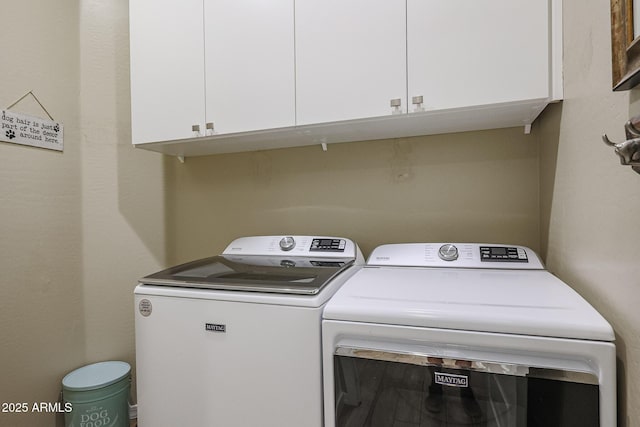 washroom with cabinets and washing machine and dryer