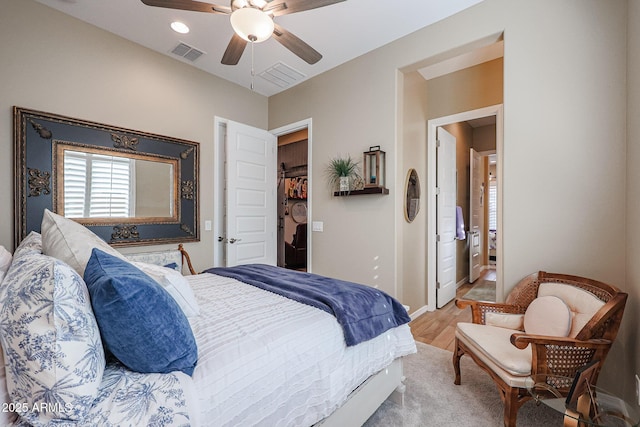 bedroom featuring ceiling fan, a closet, and light hardwood / wood-style floors