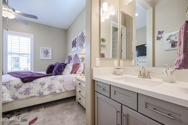 carpeted bedroom with ceiling fan and sink