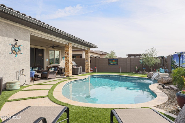 view of pool featuring ceiling fan, pool water feature, and a patio