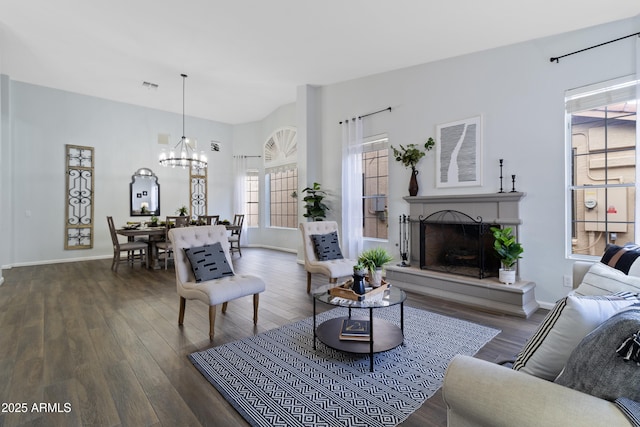 living room featuring an inviting chandelier and dark hardwood / wood-style floors